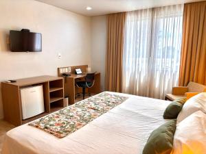 Una cama o camas en una habitación de Flat Executivo in Fórum Manaus - BlueTree