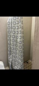 a bathroom with a toilet and a shower curtain at Leo's place in Rosarito Beach