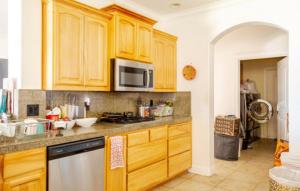 a kitchen with wooden cabinets and a stainless steel appliance at The Ark in Redding