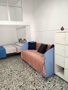a room with two beds and a couch in it at Dolce Riposo in Trani