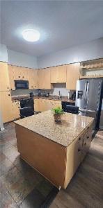 a kitchen with a island in the middle of it at One-Bedroom Condo with City Views and Resort Amenities in Long Beach