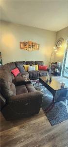 a living room with a brown couch and a coffee table at One-Bedroom Condo with City Views and Resort Amenities in Long Beach