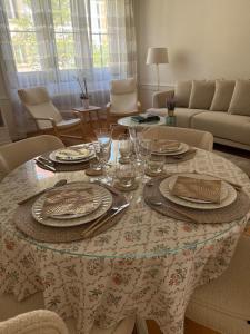 a dining room table with plates and glasses on it at V&V La Vie Est Belle in Neuchâtel +14 photos