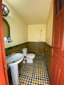 a bathroom with a toilet and a sink at Riad Iman in Fès