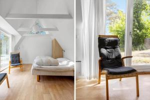 a bedroom with a bed and a chair and a window at 3647-Nexo-Frederiksvej-8-A in Neksø