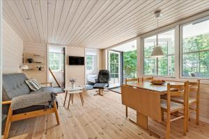 a living room with a table and a couch at 4754-Ronne-Stampen-Vej-8-Hus-5 in Rønne