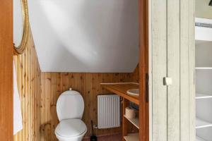 a bathroom with a toilet and a sink at 4795-Ronne-Varpelokken-9 in Rønne +17 photos