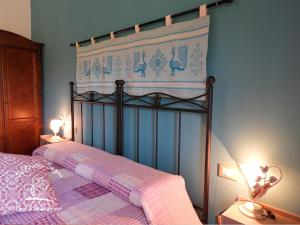 a bedroom with a bed with a pink and white blanket at B&B Su Frascu Segau in Teulada