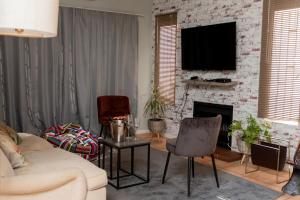 a living room with a couch and a fireplace at Chic and Secure Phakalane Stay in Gaborone