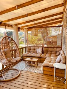 a living room with a couch and a swing at Magnifique Mobil home avec vue in Lège-Cap-Ferret