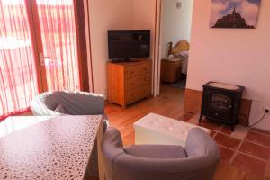 a living room with two chairs and a fireplace at Rouge - 3 star ground floor apartment in Mantilly