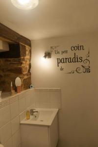 a bathroom with a toilet and a sink and a light at Rouge - 3 star ground floor apartment in Mantilly +6 photos