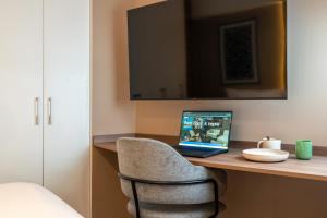 a laptop computer sitting on a desk in a room at Exclusive Mariano Santos 179 Residences by Geko in Lima