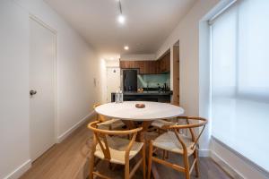 a small kitchen with a table and chairs at Exclusive Mariano Santos 179 Residences by Geko in Lima
