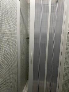 a shower stall with a glass door in a bathroom at Appartamento Santi in Fiumalbo +16 photos