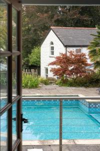 a view of a swimming pool from a window at The Old Farmhouse in Ponsanooth +58 photos