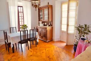 a dining room with a table and some chairs at Casa Los Lomas in Arenas de Iguña