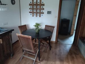 a black table with chairs and a plant on it at Dreamcatcher in Straupe