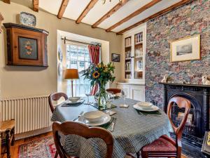 a dining room with a table and a fireplace at 3 Bed in Hawkshead Village LLH34 in Hawkshead
