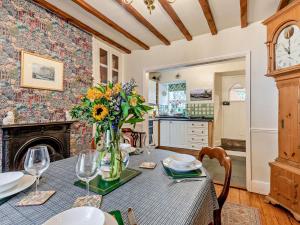 a dining room with a table with a vase of flowers at 3 Bed in Hawkshead Village LLH34 in Hawkshead +12 photos