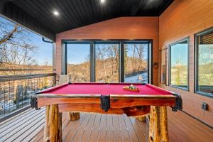 a pool table on the deck of a house at Downtown Dreamin in Gatlinburg