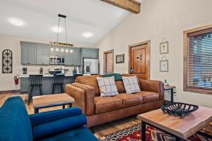 a living room with a couch and a kitchen at Downtown Dreamin in Gatlinburg