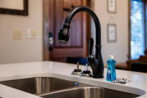 a kitchen sink with a black faucet at Downtown Dreamin in Gatlinburg +38 photos