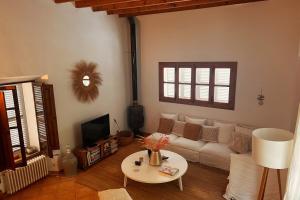 a living room with a couch and a table at Luxurious finca with pool, Soller - Mallorca in Sóller