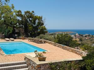 a swimming pool with a view of the ocean at Villa Oleandar in Posidhonía