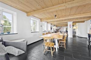a kitchen and dining room with a table and chairs at 4731-Aakirkeby-Dalegardsvej-13 in Åkirkeby