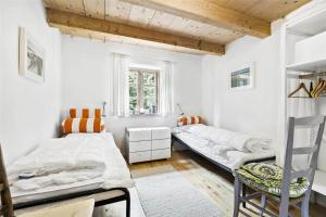 a bedroom with two beds and a window at 4731-Aakirkeby-Dalegardsvej-13 in Åkirkeby