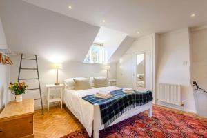 ein Schlafzimmer mit einem Bett, einer Leiter und einem Fenster in der Unterkunft Dale Cottage in East Rudham