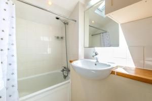 ein Badezimmer mit Waschbecken, Badewanne und Spiegel in der Unterkunft Dale Cottage in East Rudham + 9 Fotos
