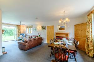 a living room with a couch and a table at Brights Farm Lodge in Bramfield