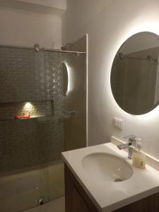 a bathroom with a sink and a mirror and a shower at Casa Nueva en Zapatoca in Zapatoca +14 photos