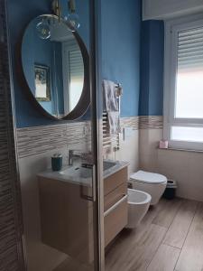 a bathroom with a sink and a toilet and a mirror at my house intero appartamento in stazione in Pisa +13 photos