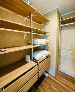 a room with wooden shelves with two beds at Arauco Premium Suite in Santiago