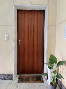 a wooden door with a plant in front of it at moon 6 in Mestre