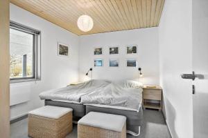 a bedroom with a bed and a desk and a window at OH333-Storvorde-Frydenstrand-56 in Storvorde +21 photos