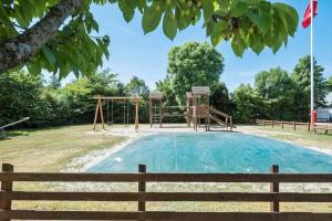 a playground in a park with a wooden fence at OH333-Storvorde-Frydenstrand-56 in Storvorde