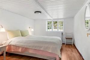 a white bedroom with a large bed and two windows at OH397-Storvorde-Kystvej-171 in Storvorde
