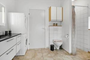 a white bathroom with a toilet and a sink at HA173-Asaa-Knirren-6-B in Aså +16 photos