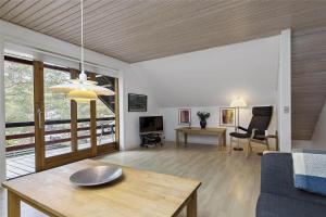 a living room with a table and a couch at 3605-Nexo-Skelvej-3-A in Neksø