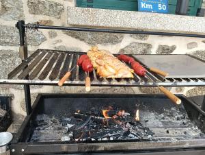 a grill with some meat and sausages on it at alma de quireza in Santo Tomé
