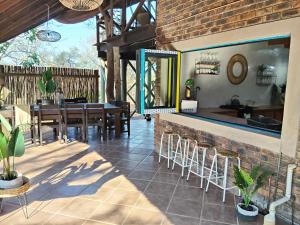 a dining room with a table and chairs at Edjami River View in Marloth Park