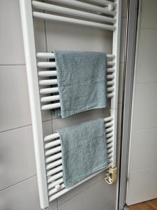 a towel rack in a bathroom with towels at FeWo Rose 52 Travemünde in Travemünde +29 photos
