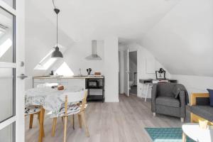 a kitchen and living room with a table and chairs at 4790-Ronne-Kanegardsvej-12-1 in Rønne +11 photos