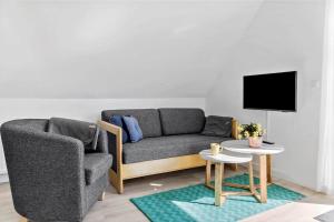 a living room with a couch and a table at 4790-Ronne-Kanegardsvej-12-1 in Rønne