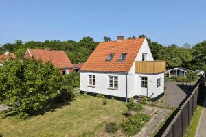 an aerial view of a white house with an orange roof at 4790-Ronne-Kanegardsvej-12-1 in Rønne