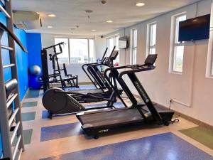 a gym with several tread machines in a room at Apart-hotel Premium Adrianópolis in Manaus